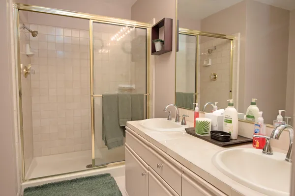 a bathroom with a mirror sink and shower