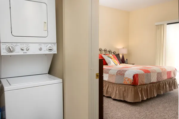 a bedroom with a bed and a mirror
