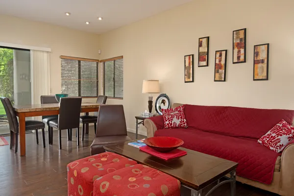 a living room with furniture and wooden floor