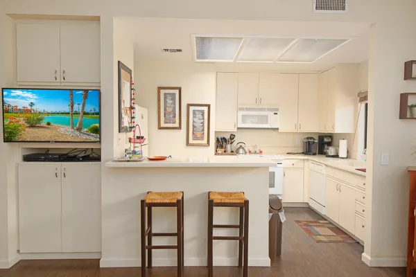 a kitchen with stainless steel appliances white cabinets and a refrigerator