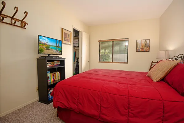 a bedroom with a bed and a flat screen tv