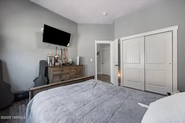 a bedroom with a bed and a flat screen tv