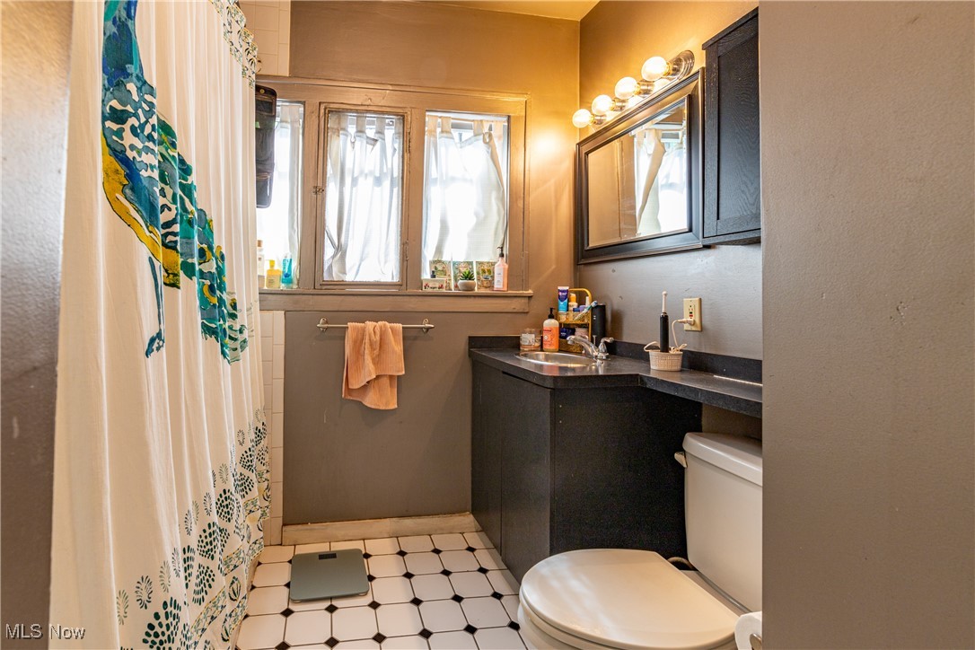 3232 Clarendon Road Cleveland, OH 44118 - Photo 12 of 22 Bathroom with vanity, toilet, a shower with curtain, and tile patterned floors