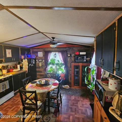 a bedroom with a bed a mirror and paintings on the wall
