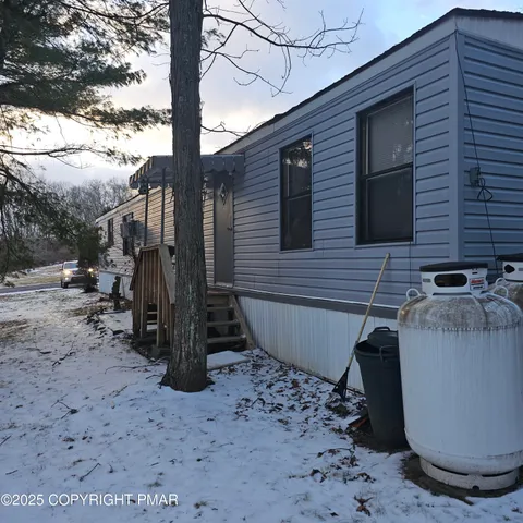 a kitchen with stainless steel appliances granite countertop a sink a stove and a dining table with wooden floor