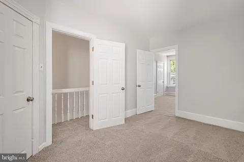 an empty room with windows and closet