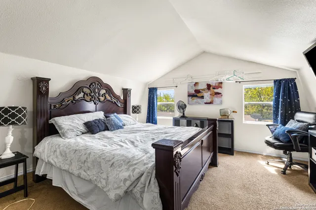 a bedroom with a bed and a desk