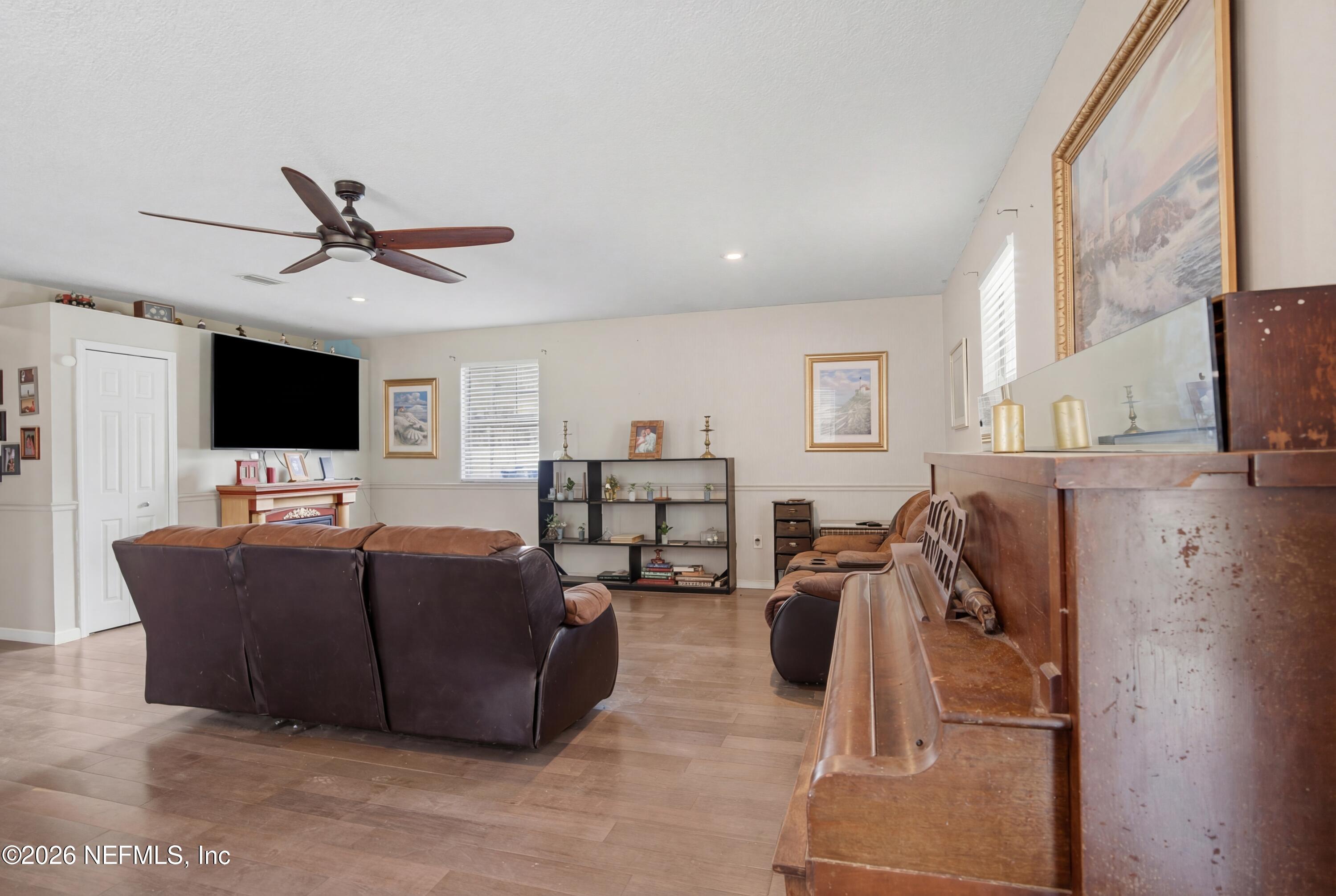 4111 Cedar Point Road Jacksonville, FL 32226 - Photo 5 of 14 a living room with furniture and a flat screen tv