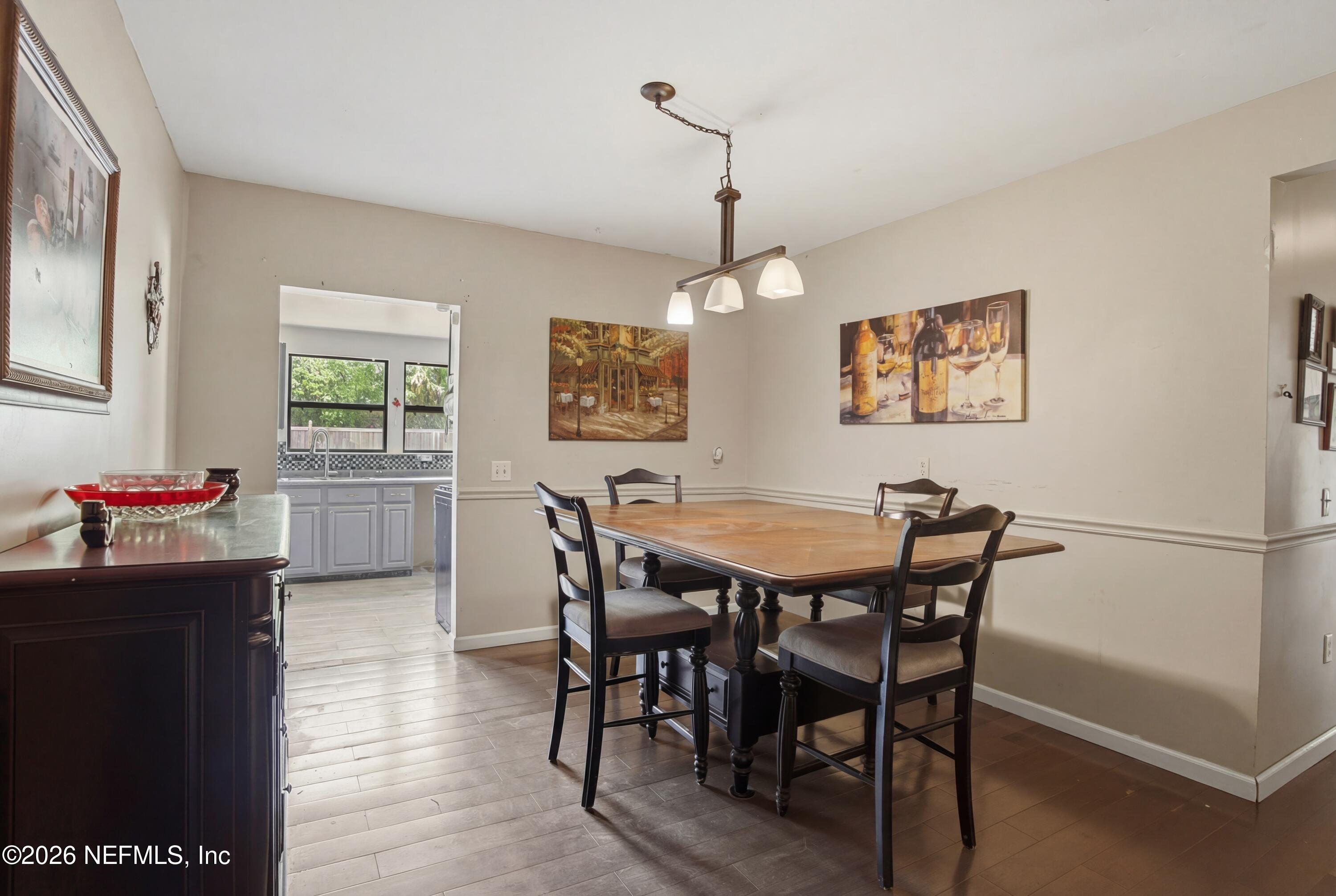 4111 Cedar Point Road Jacksonville, FL 32226 - Photo 6 of 14 a view of a dining room with furniture window and wooden floor