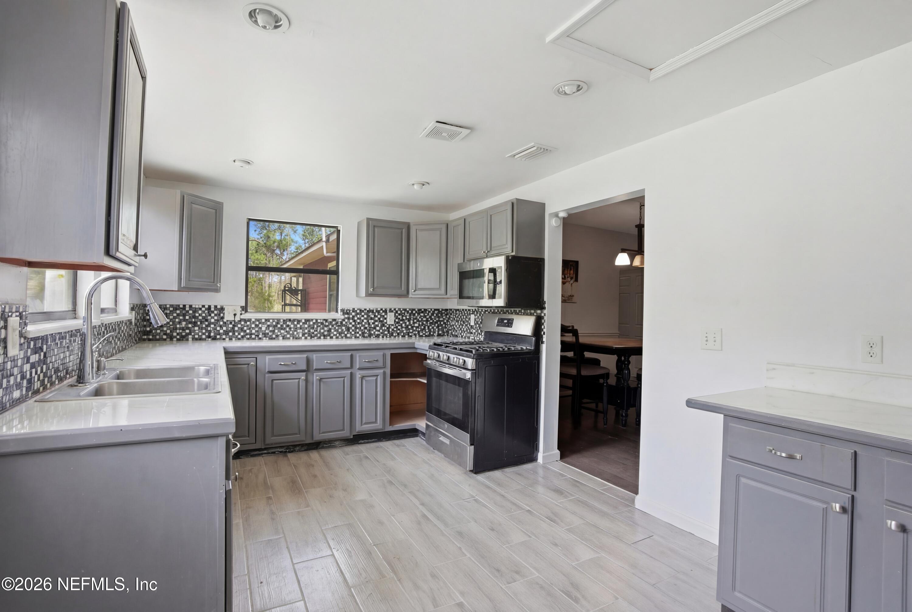 4111 Cedar Point Road Jacksonville, FL 32226 - Photo 8 of 14 a kitchen with a sink stove and refrigerator