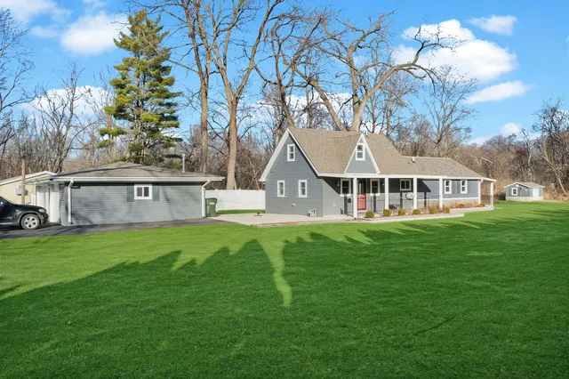 a front view of a house with a yard table and chairs