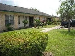 a front view of house with yard and outdoor seating