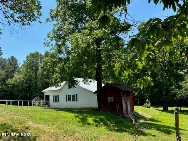 239 Miller Road Pikeville, TN 37367 - Photo 4 of 29 a front view of a house with garden