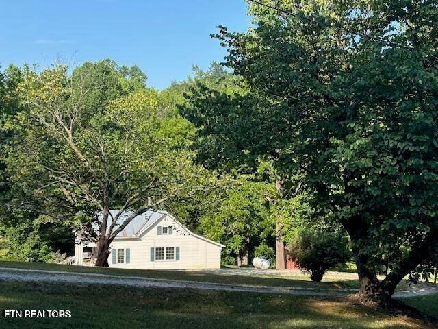 239 Miller Road Pikeville, TN 37367 - Photo 8 of 29 a white house in middle of forest