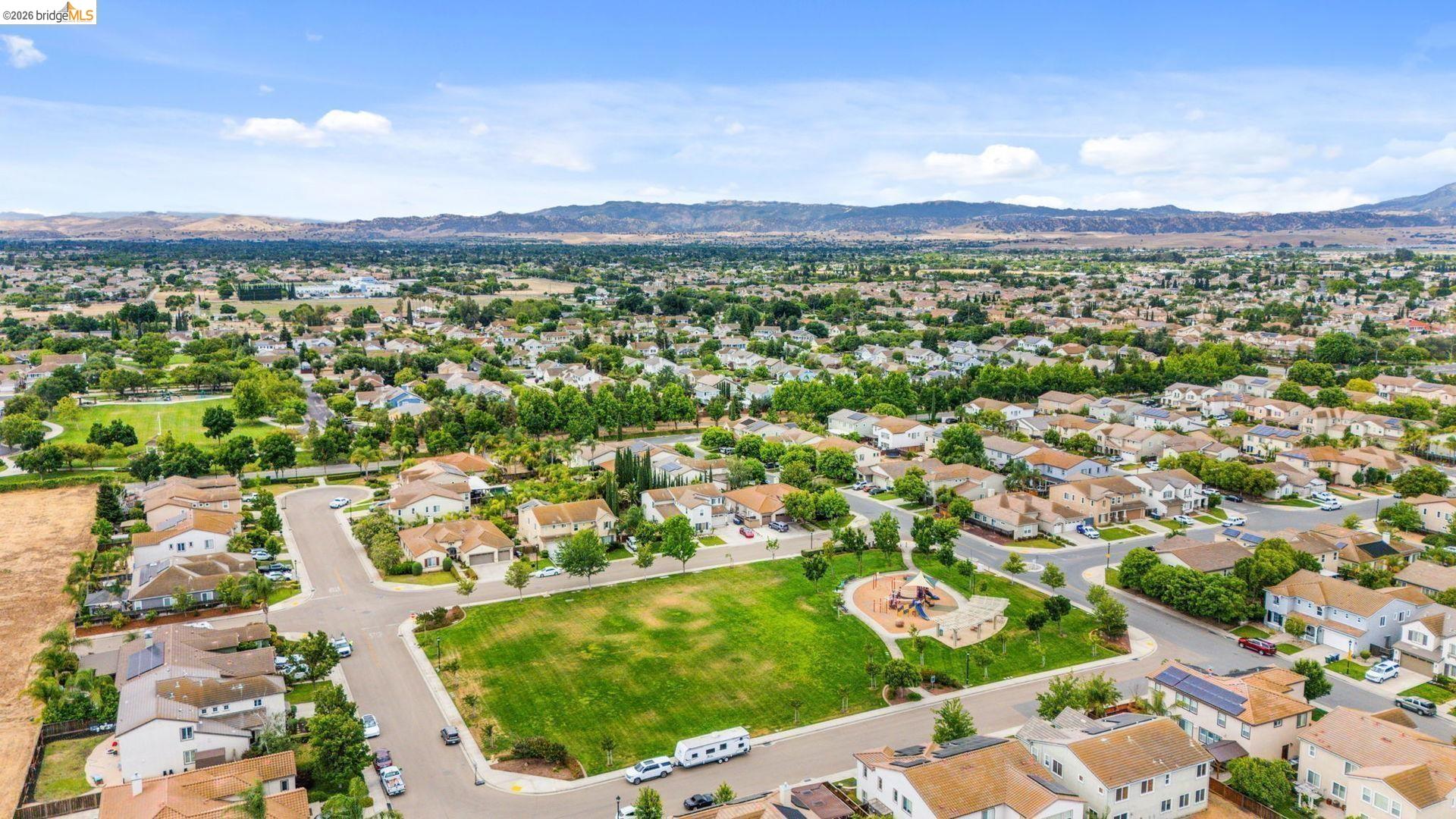 700 Brownstone Road Oakley, CA 94561 - Photo 5 of 58 Aerial perspective showcasing a residential neighborhood with a central green space
