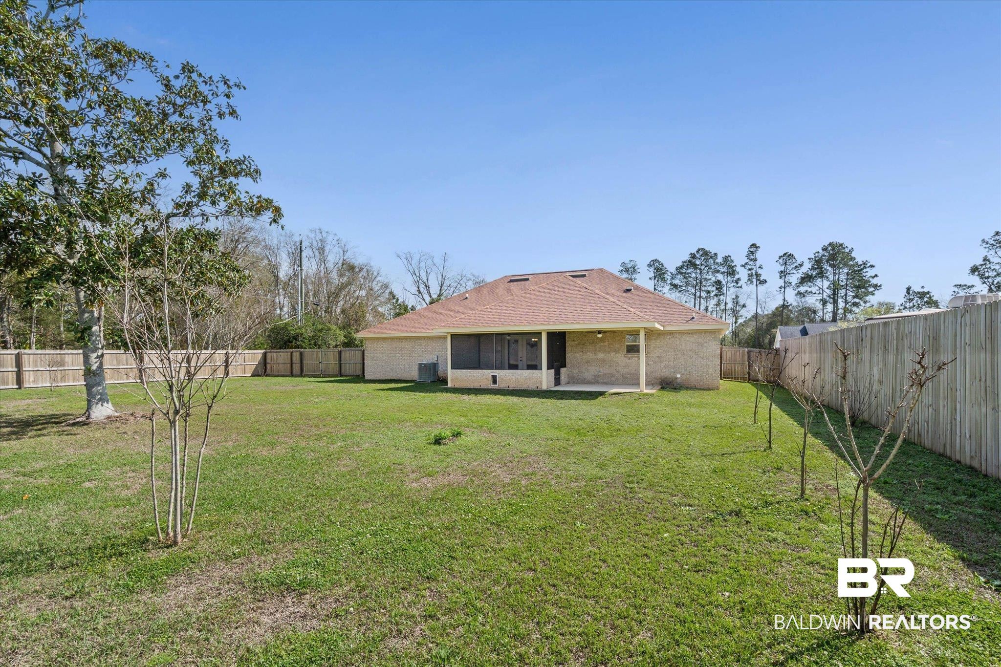 101 Washington Boulevard Foley, AL 36535 - Photo 28 of 32 Rear view of house with a patio area, brick siding, and a fenced backyard