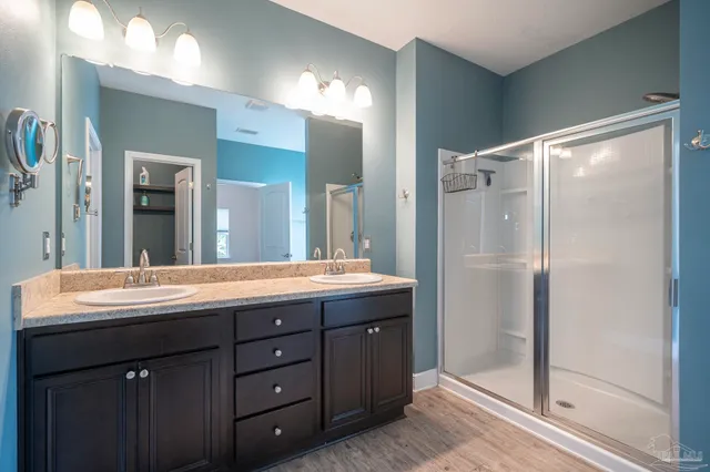 a bathroom with a granite countertop sink mirror and double