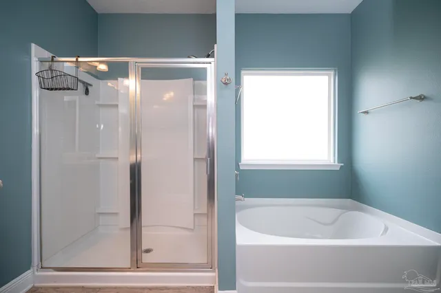 a bathroom with a bathtub and a shower