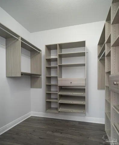 a view of walk in closet with empty racks