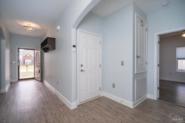 a view of a hallway with wooden floor