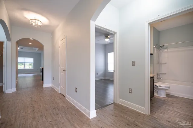 a bathroom view of a toilet and a mirror
