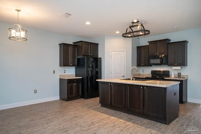 a kitchen with stainless steel appliances a sink stove and refrigerator