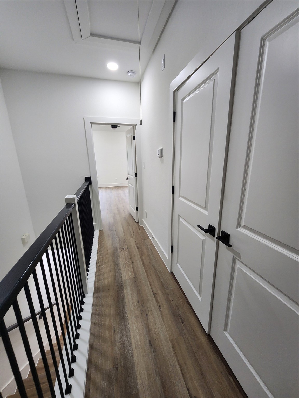 650 Everett Street, Unit B Conroe, TX 77301 - Photo 11 of 20 a view of a hallway with wooden floor and staircase
