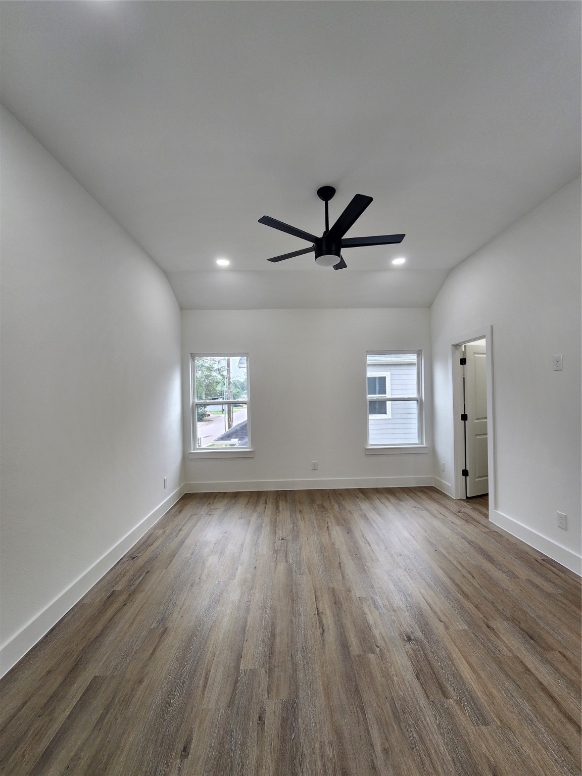 650 Everett Street, Unit B Conroe, TX 77301 - Photo 15 of 20 a view of empty room with wooden floor and window