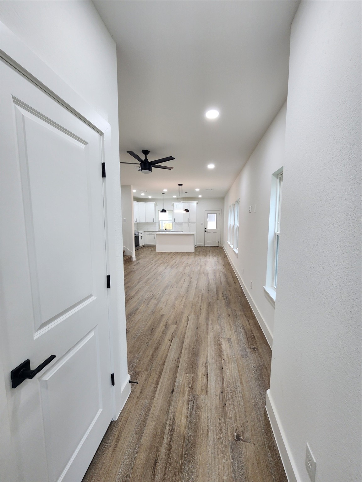650 Everett Street, Unit B Conroe, TX 77301 - Photo 2 of 20 a view of a hallway with wooden floor and staircase