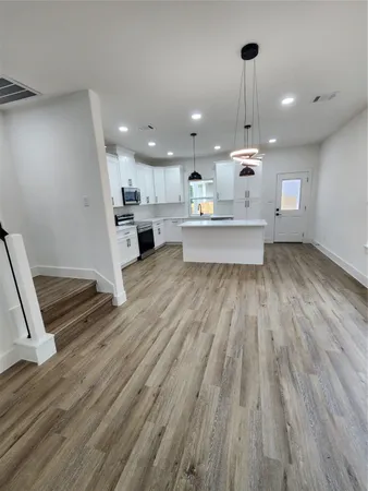a view of kitchen with sink and wooden floor