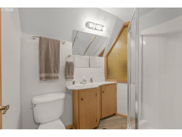 a bathroom with a sink a toilet and mirror