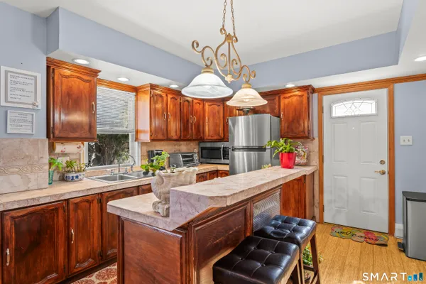 a kitchen that has a lot of cabinets stove and a sink