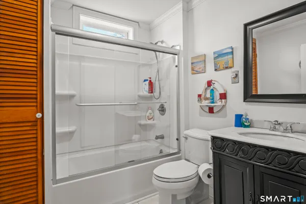 a bathroom with a sink a toilet and a shower