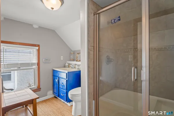 a bathroom with a sink toilet and shower
