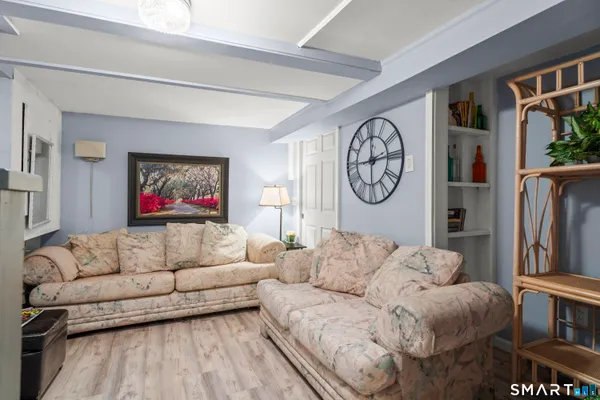a living room with furniture a flat screen tv and a large window