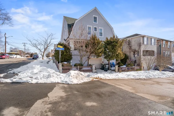 a view of a house with snow on the road