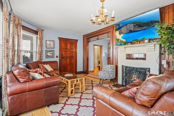 a living room with furniture fireplace and a window
