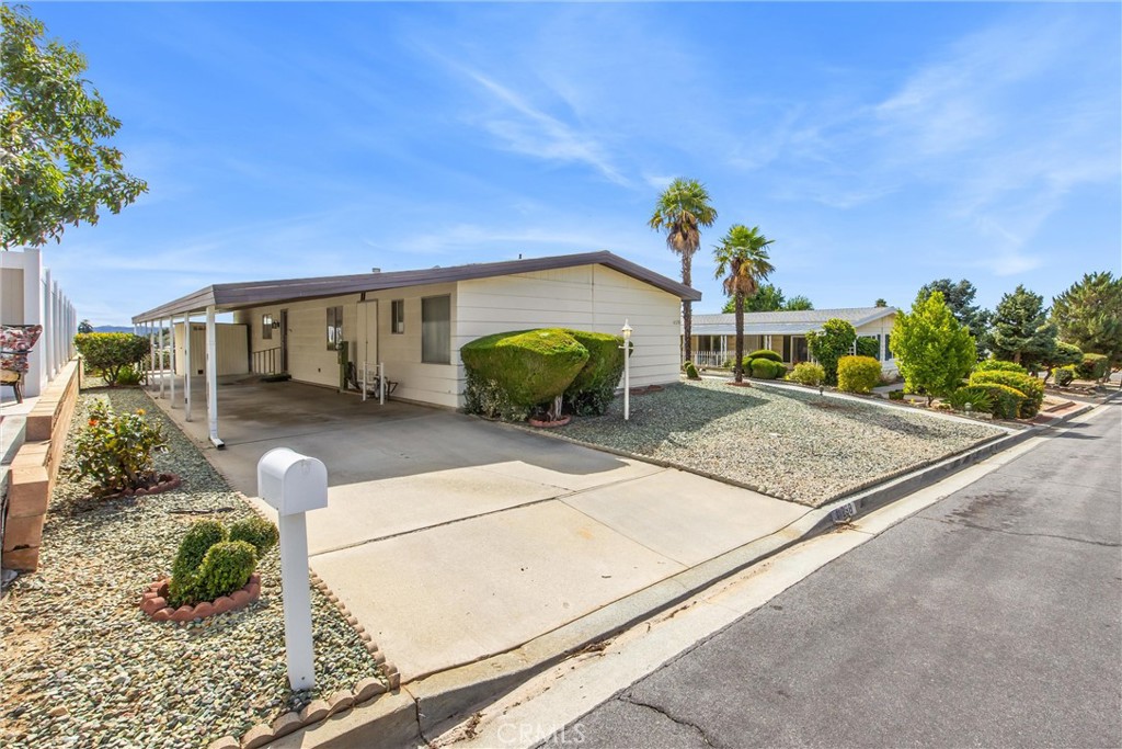 41238 Cheyenne Trail Cherry Valley, CA 92223 - Photo 1 of 44 a front view of a house with garden