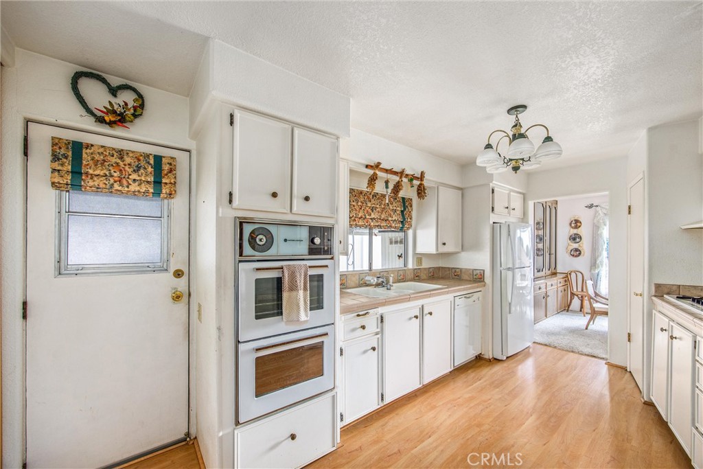 41238 Cheyenne Trail Cherry Valley, CA 92223 - Photo 11 of 44 a kitchen with stainless steel appliances a stove a sink and a refrigerator