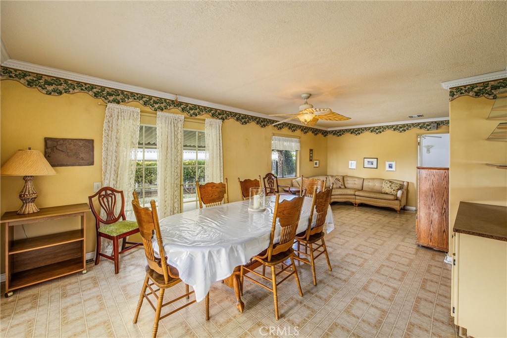 41238 Cheyenne Trail Cherry Valley, CA 92223 - Photo 13 of 44 a view of a dining room with furniture and a chandelier