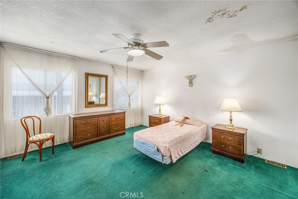 41238 Cheyenne Trail Cherry Valley, CA 92223 - Photo 21 of 44 a bedroom with a bed and a couch