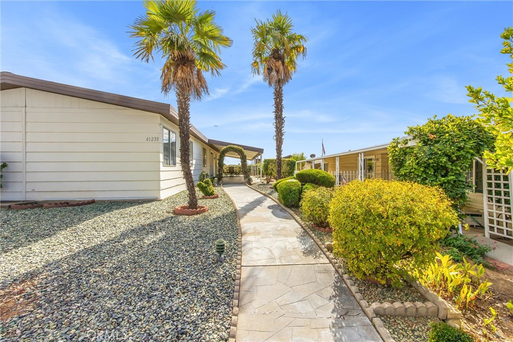 41238 Cheyenne Trail Cherry Valley, CA 92223 - Photo 26 of 44 a front view of a house with garden