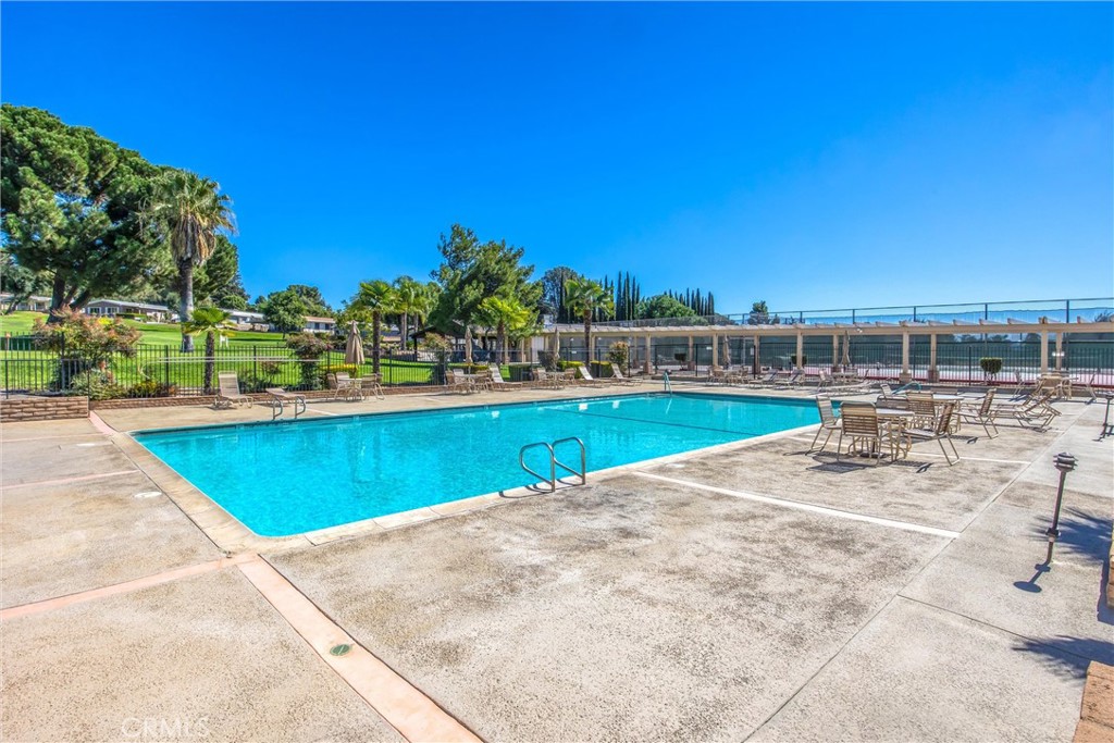 41238 Cheyenne Trail Cherry Valley, CA 92223 - Photo 39 of 44 a view of a swimming pool with an outdoor seating and a yard