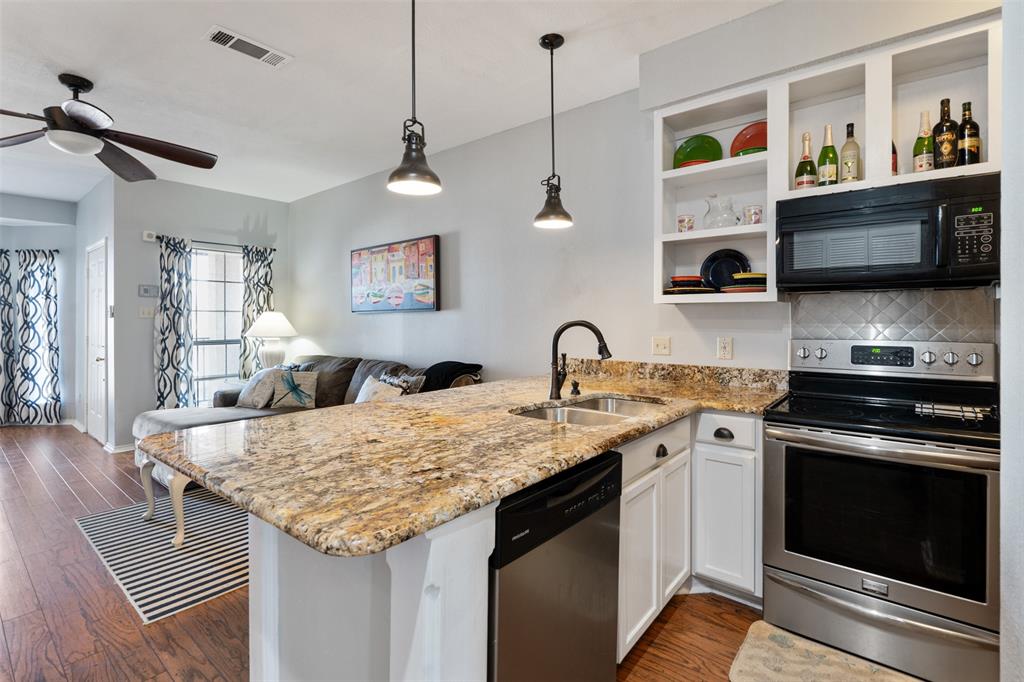 1933 Island Circle, Unit B209 Tool, TX 75143 - Photo 12 of 30 a kitchen with granite countertop stainless steel appliances a sink stove and refrigerator