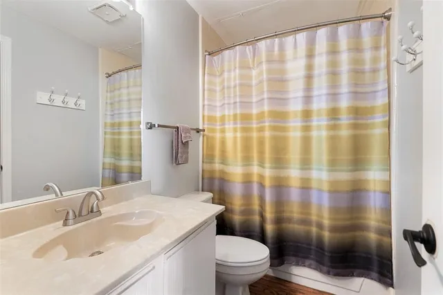 a bathroom with a sink toilet and shower