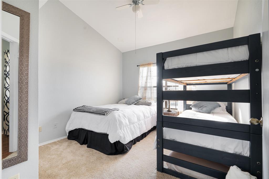 1933 Island Circle, Unit B209 Tool, TX 75143 - Photo 17 of 30 a bedroom with a bed and a chandelier