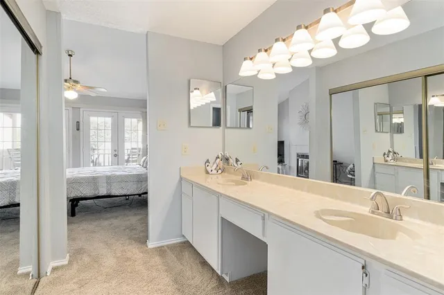a spacious bathroom with a tub sink and mirror
