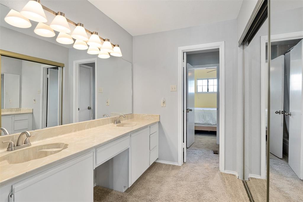 1933 Island Circle, Unit B209 Tool, TX 75143 - Photo 20 of 30 a spacious bathroom with a granite countertop sink a large mirror and a shower