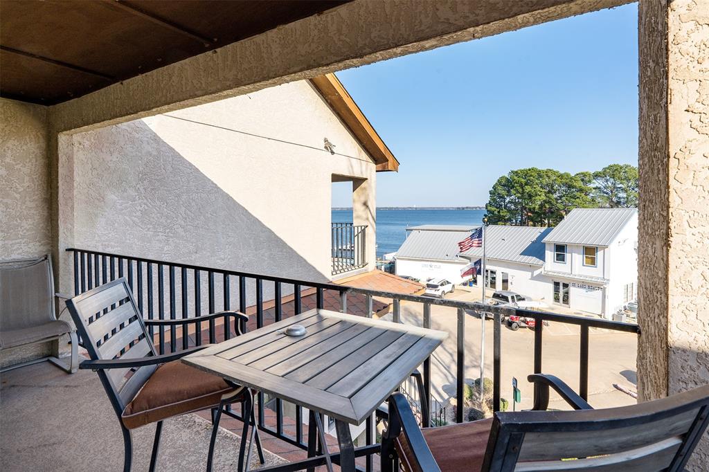 1933 Island Circle, Unit B209 Tool, TX 75143 - Photo 24 of 30 a view of balcony with wooden floor and outdoor seating
