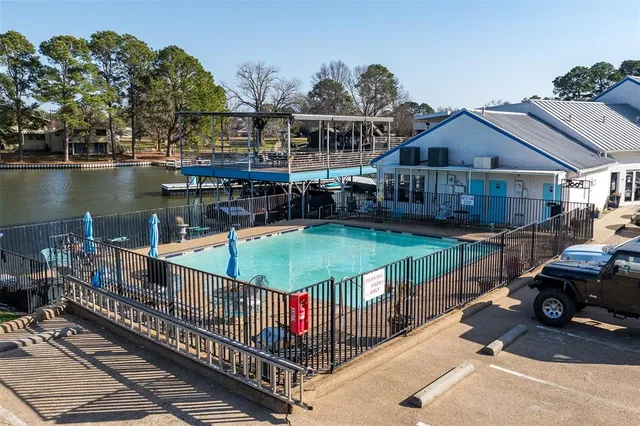 a view of a house with swimming pool and sitting area
